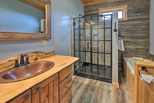 a bathroom with a sink and a shower at Hillside Hideaway with Hot Tub and Heated Patio! in Baraboo