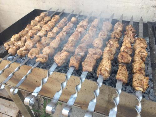 a bunch of food cooking on a grill at Villa Angel in Kamenari