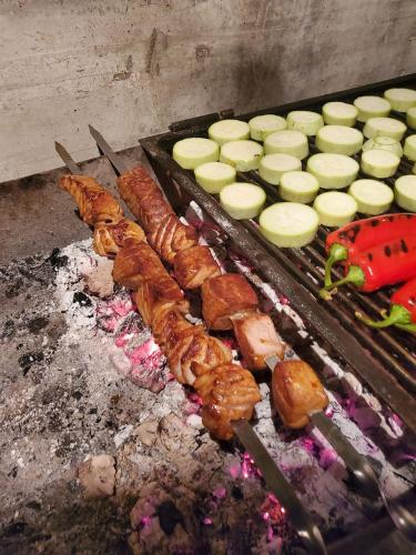 a grill with meat and vegetables on it at Villa Angel in Kamenari