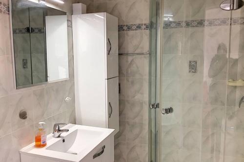 une salle de bain avec un lavabo et une douche dans l'établissement AiguesMarines, à Cagnes-sur-Mer