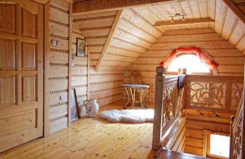 a room with a staircase in a log cabin at Chata u Rodaka in Snochowice