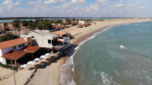 una vista aérea de una playa con casas y el océano en Pousada O Mineiro - frente a praia en Galinhos