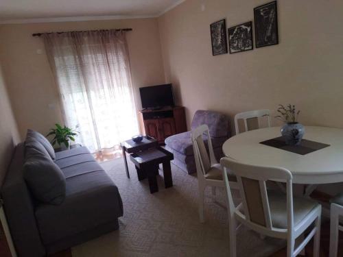 a living room with a couch and a table at Apartment Nibim in Bijela
