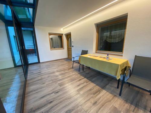 a room with a yellow table and chairs in it at Pradat in La Valle