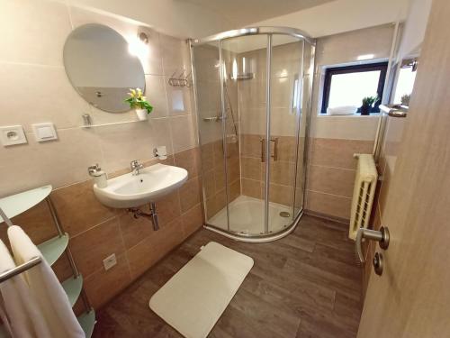 a bathroom with a shower and a sink at Apartmany Železná Ruda in Železná Ruda
