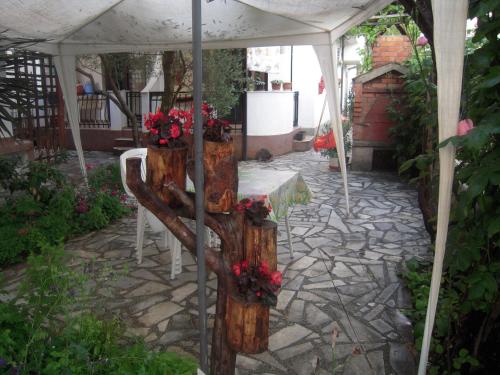 a table under a white tent with flowers on it at Lile Pestani Accommodation in Peštani