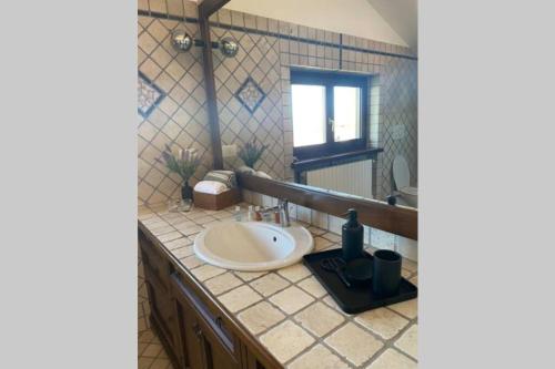 a bathroom with a sink and a window at La Vista Barolo in La Morra in La Morra