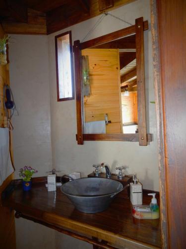 a bathroom with a sink and a mirror at Cabañas Alechen in El Calafate