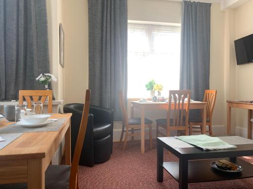 a living room with a table and a dining room at St Anne's Road Guest House in Exeter