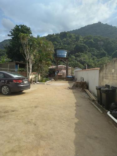 a car parked in a parking lot with a water tower at Pousada Marimbá in Trindade