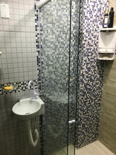 a bathroom with a shower and a sink at Pousada O Mineiro - frente a praia in Galinhos