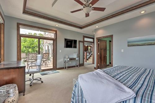 a bedroom with a bed and a desk and a table at Boat Dock and Kayaks Luxury Lake of the Ozarks Home in Kaiser