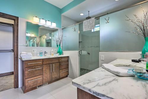 a bathroom with a sink and a large mirror at Luxury Lake of the Ozarks Home with Boat Dock! in Kaiser