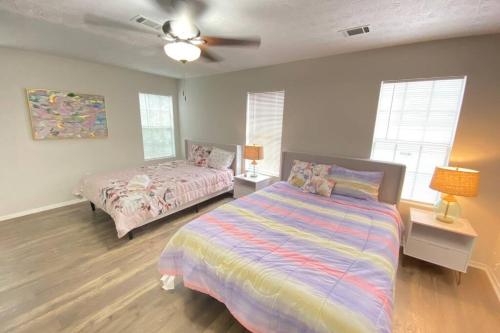 a bedroom with two beds and a ceiling fan at Trendy Renovated House/ Get Away to Downtown Norcross in Norcross