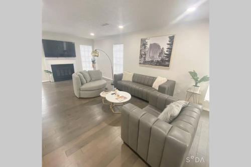 a living room with a couch and chairs and a table at Trendy Renovated House/ Get Away to Downtown Norcross in Norcross