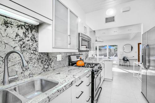 a kitchen with a sink and a counter top at Riviera Palm Springs Permit# 2044 in Palm Springs