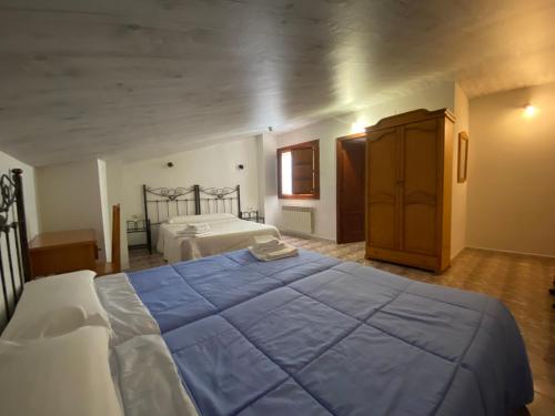 a large bedroom with two beds and a dresser at Hostal La Alberca in La Alberca