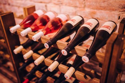 a bunch of wine bottles in a wine rack at Chalupa Šakvice l Jižní Morava l Pálava in Šakvice
