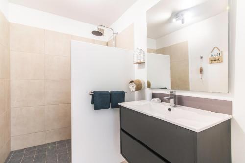 a bathroom with a sink and a mirror at BLUE WAVE - 2 bedrooms - Orient Beach! in Orient Bay