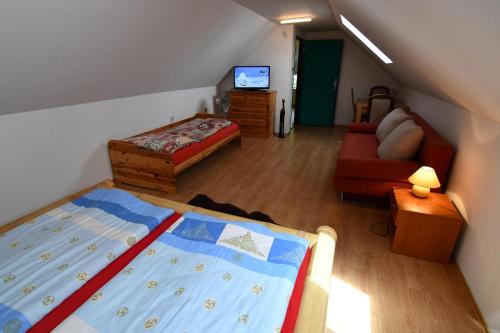 a bedroom with a bed and a living room at APARTMENTS V+K in Tatranska Strba