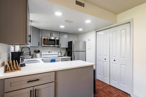 a kitchen with white cabinets and a white counter top at Amazing 2 Bedroom Townhouse near beach in Indialantic