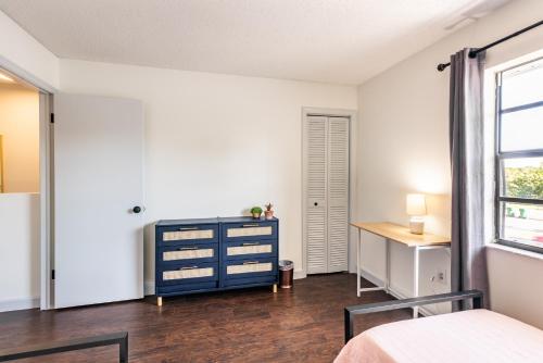a bedroom with a blue dresser and a window at Amazing 2 Bedroom Townhouse near beach in Indialantic