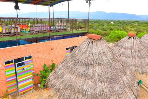 a group of straw huts on top of a building at Tubo Hotel La Tatacoa in Villavieja