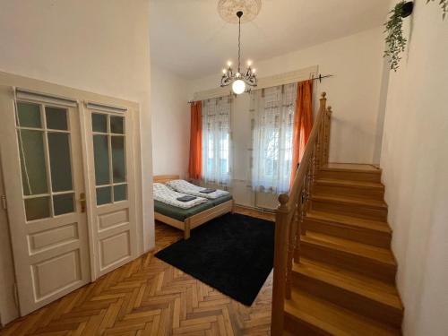 A bed or beds in a room at Lyrius Vendégház - Debrecen
