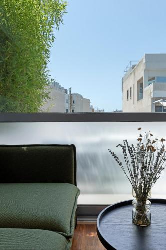a room with a table and a chair and a window at The Athenians Art Apartments in Athens