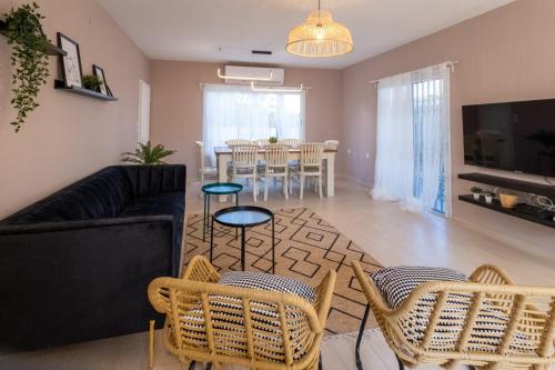 a living room with a couch and chairs and a table at Eilat vacation house דירות נופש אילת in Eilat