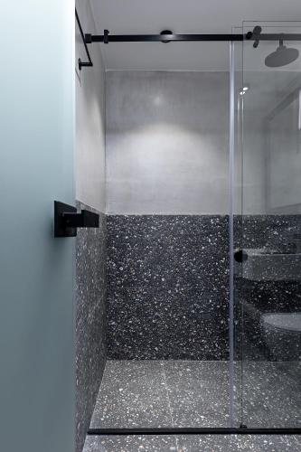 a shower with a glass door in a bathroom at The Athenians Art Apartments in Athens
