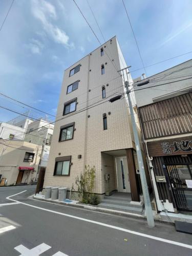 a tall brick building on the side of a street at PRISM INN Asakusa in Tokyo