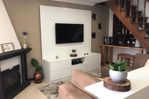 a living room with a television on a wall at #GC House in Ponta Delgada