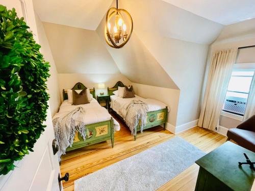 a room with two beds and a potted plant at Vida Boutique Inn in Worcester