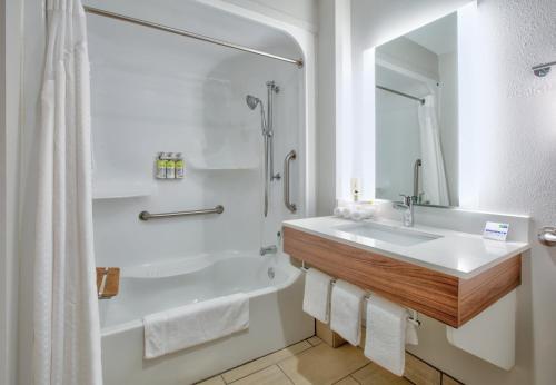 a bathroom with a tub and a sink and a shower at Holiday Inn Express - Hope by IHG in Hope