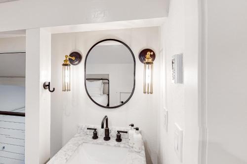 a white bathroom with a sink and a mirror at Fish Creek Point in Wilson