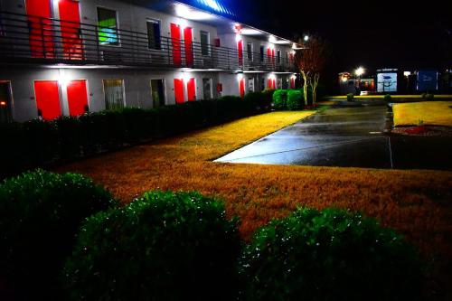 a building with red and green lights on a street at Economy Inn Little Rock in Little Rock