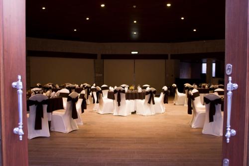 a group of tables and chairs in a room at Holiday Inn Queretaro Centro Historico by IHG in Querétaro