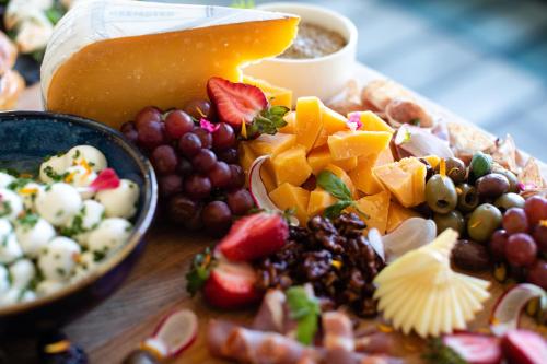 a plate of food with fruit and cheese on a table at Hotel Indigo Seattle Everett Waterfront Place by IHG in Everett