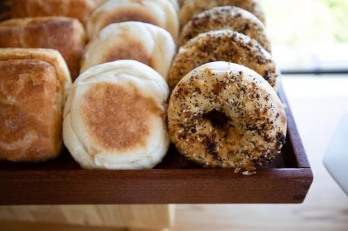 a wooden box filled with different types of donuts at Hotel Indigo Seattle Everett Waterfront Place by IHG in Everett