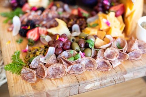 a bunch of different types of food on a cutting board at Hotel Indigo Seattle Everett Waterfront Place by IHG in Everett