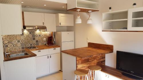 une cuisine avec des armoires blanches et un comptoir dans l'établissement Studio Bandol Centre 2 étoiles idéal emplacement, à Bandol