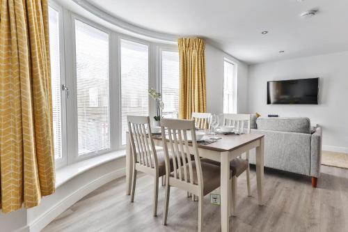 a living room with a table and chairs and a couch at Finest Retreats - Belle House, Apt 4 in Filey