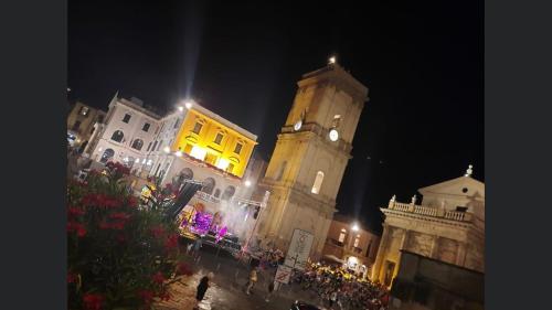 a large building with a clock tower at night at Agriturismo La Costa dei Trabocchi in Torino di Sangro