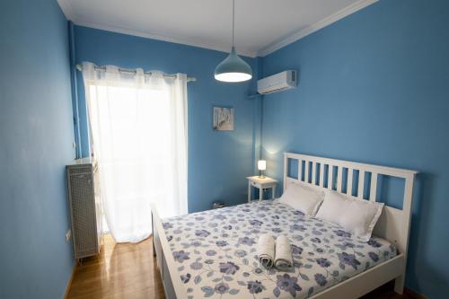 a blue bedroom with a bed with shoes on it at Blue House in Athens