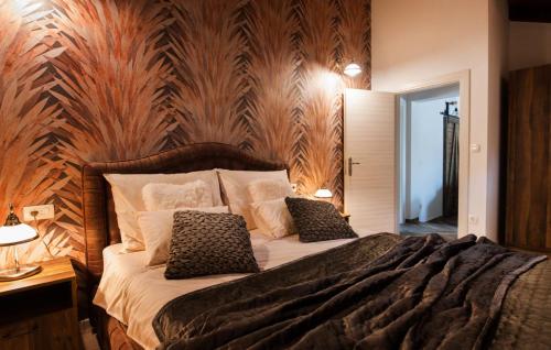 a bedroom with a bed with a wooden wall at Luxury Villa Nature with heated private pool, sauna & fire pit, a short walk to the beach in Milna