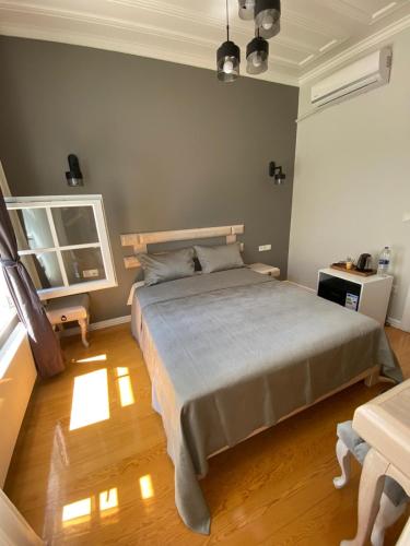 a bedroom with a large bed and a wooden floor at White Island Boutique Otel in Adalar