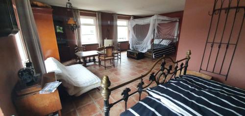 ein Schlafzimmer mit einem Bett und ein Wohnzimmer in der Unterkunft Gezinskamer van Waard van Kekerdom in Kekerdom
