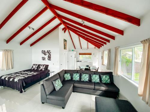 a living room with a couch and a bed at Ocean Breeze Villa in Rarotonga