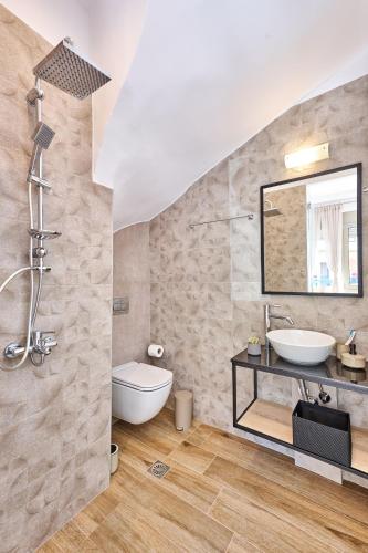 a bathroom with a sink and a mirror at City Experience Apartments A in Heraklio